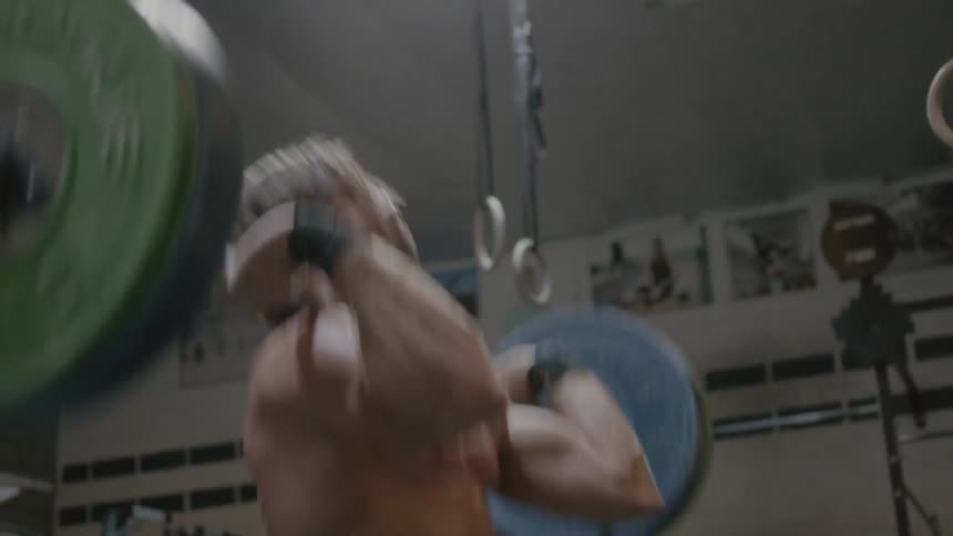 A man is lifting weights in the gym