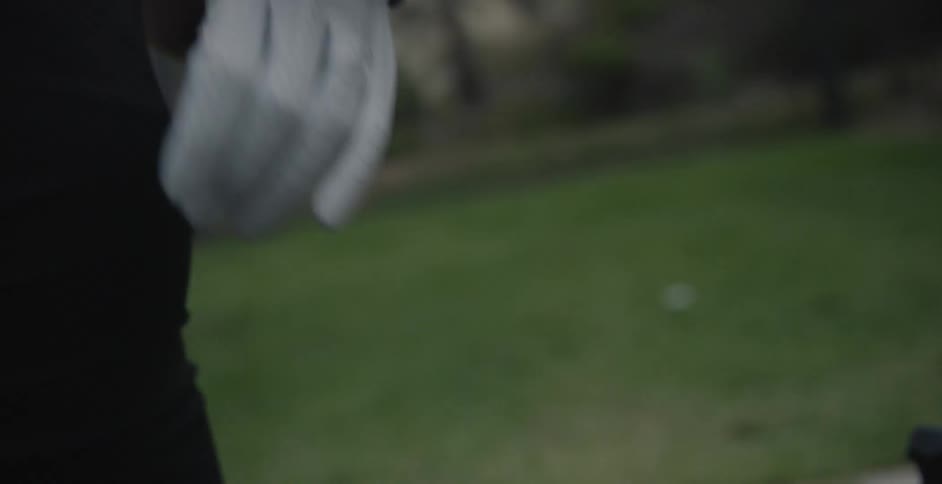 A person tightens her glove on her hand