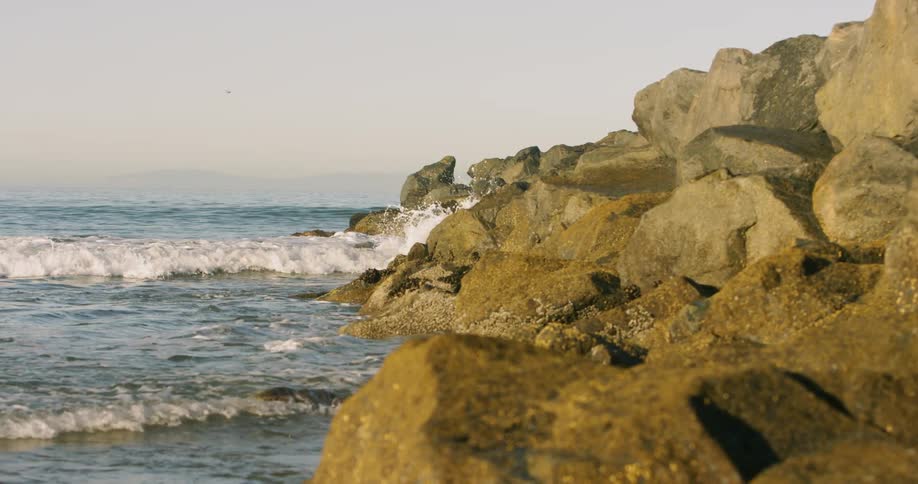 Ocean waves crash into a rocky shore