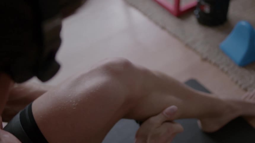 A man is massaging his lower leg