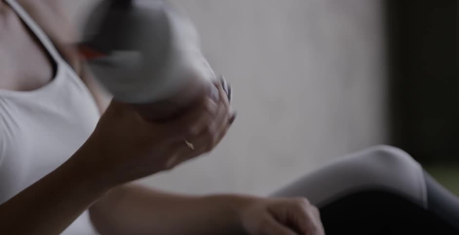 A woman mixes a protein shake