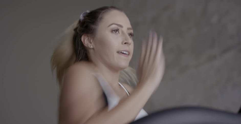A woman runs on a treadmill