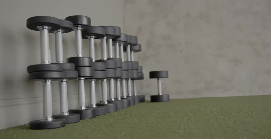 Dumbbells are stacked in a corner