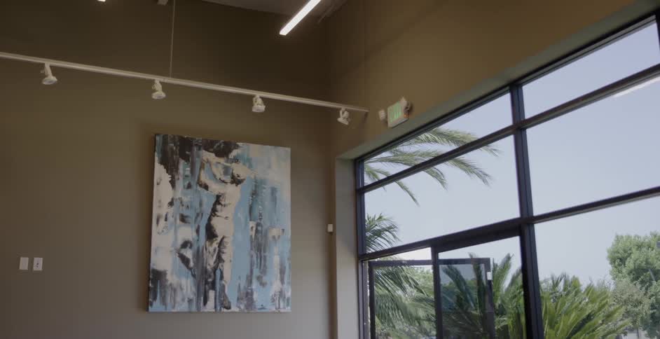 A painting is on the wall next to a doorway of a building