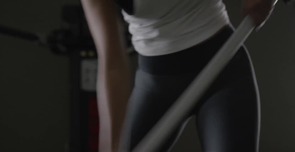Woman practices swinging a field hockey stick