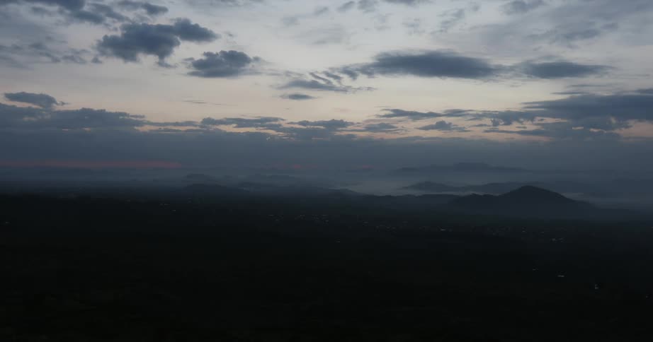 Clouds float over the horizon at sunset