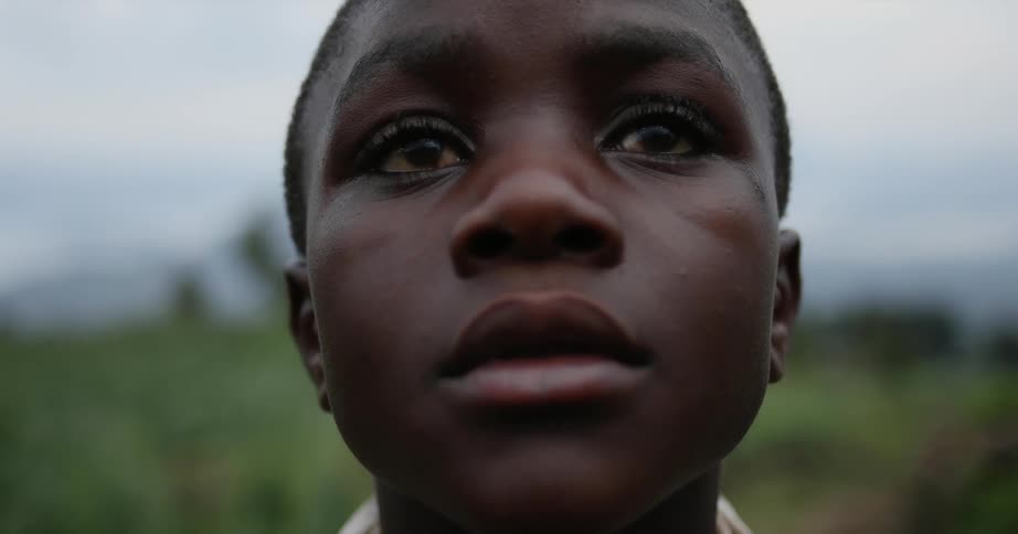 A child is staring forward with tearing eyes