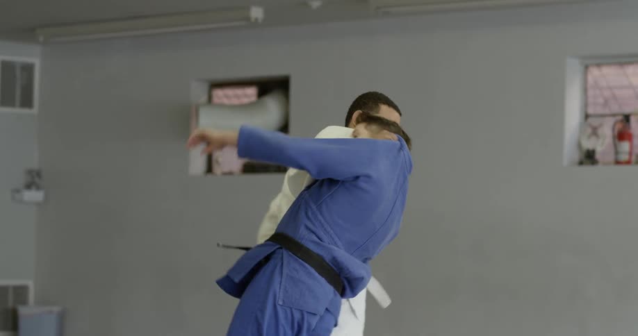 A man trips and pushes down an opponent