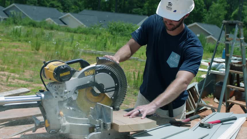 Man uses a circular saw to slice wood