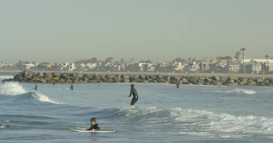 People are rising their surfboards in the water