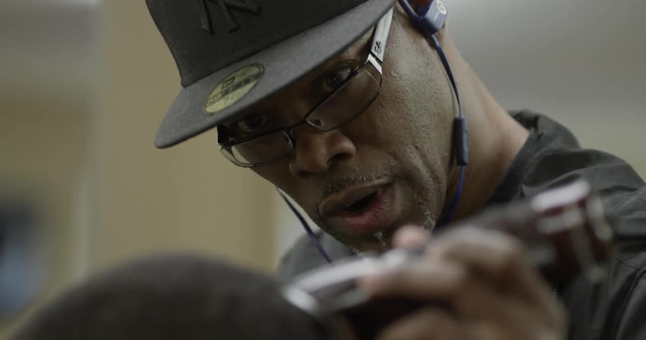 A barber trims a man's hair