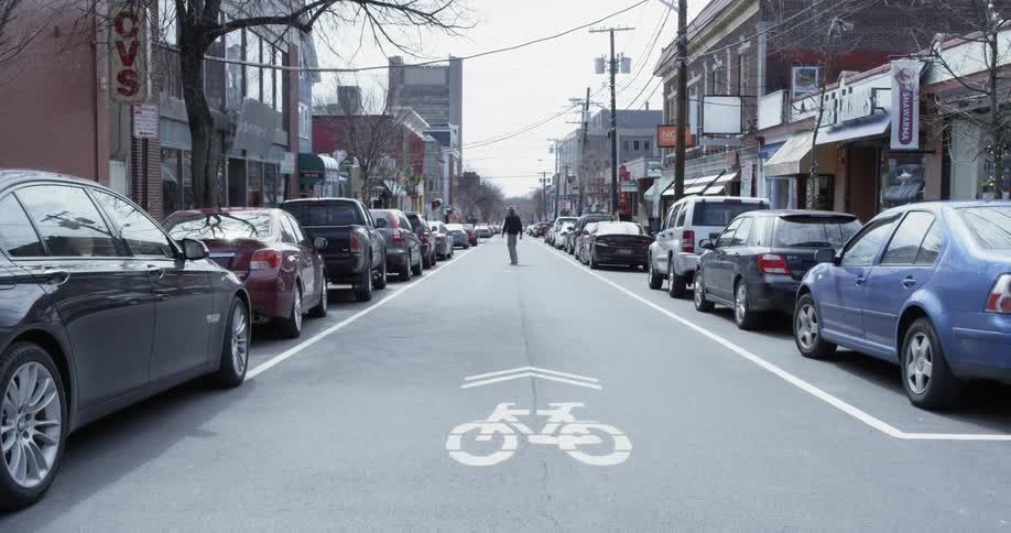 Man crosses an empty urban street
