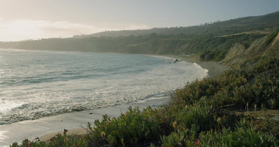 Waves roll into an island shore