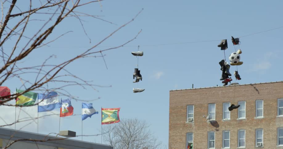 Shoes dangle from a power line in a city