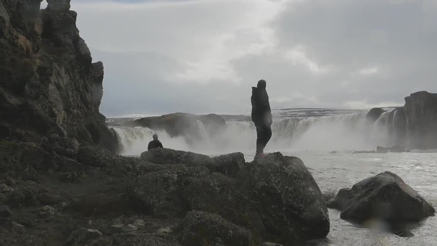 A person standing on a rock