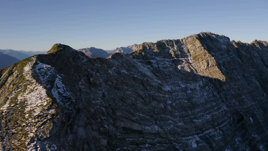 Snow dots the rocky steep mountains