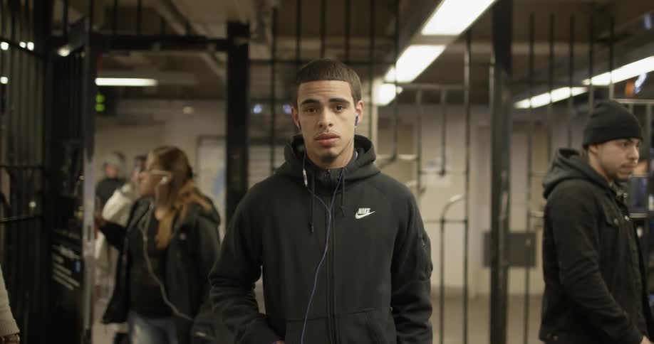 A man is waiting in the subway as others enter