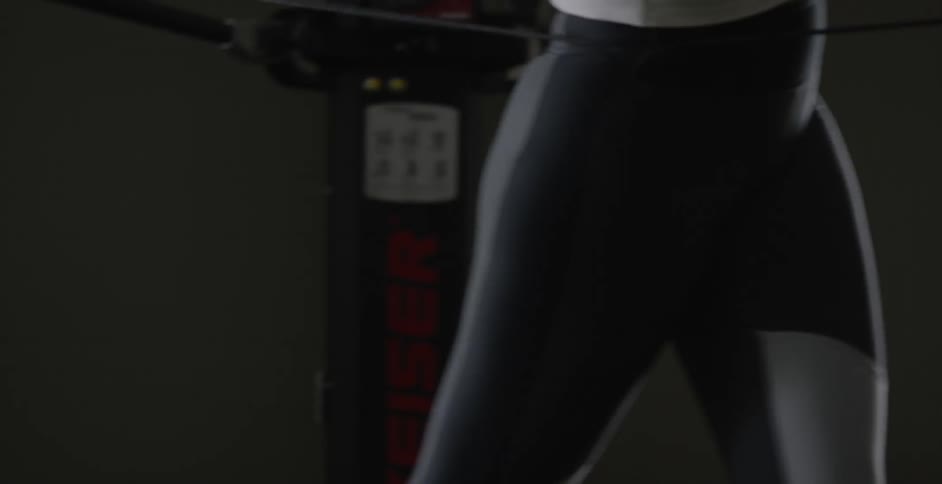 A woman exercises in a gym