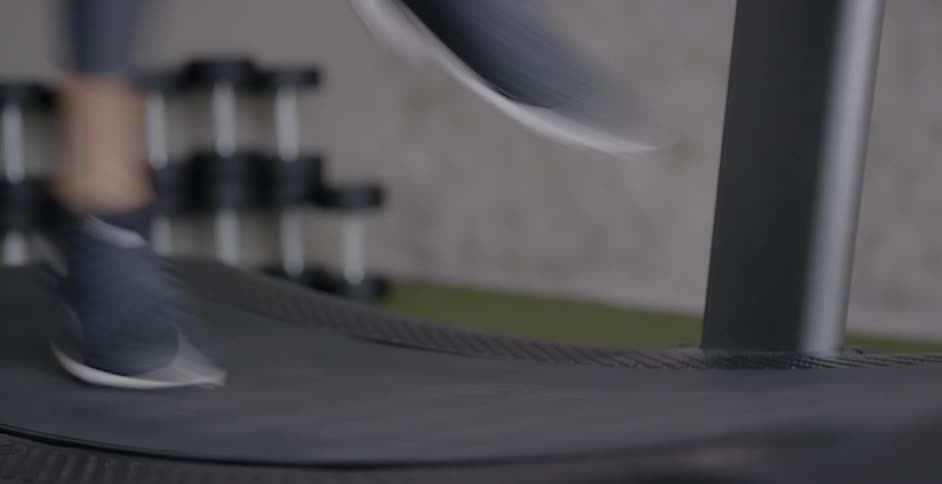 A woman runs on a treadmill