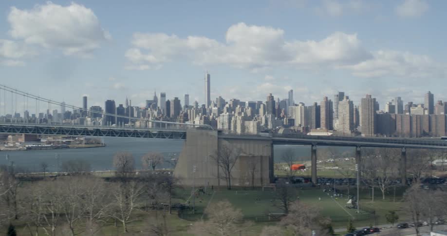 City skyline near a body of water and a bridge