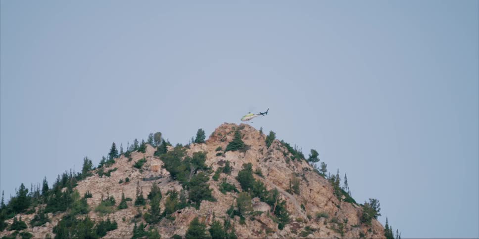 Helicopter landing on a brushy hilltop
