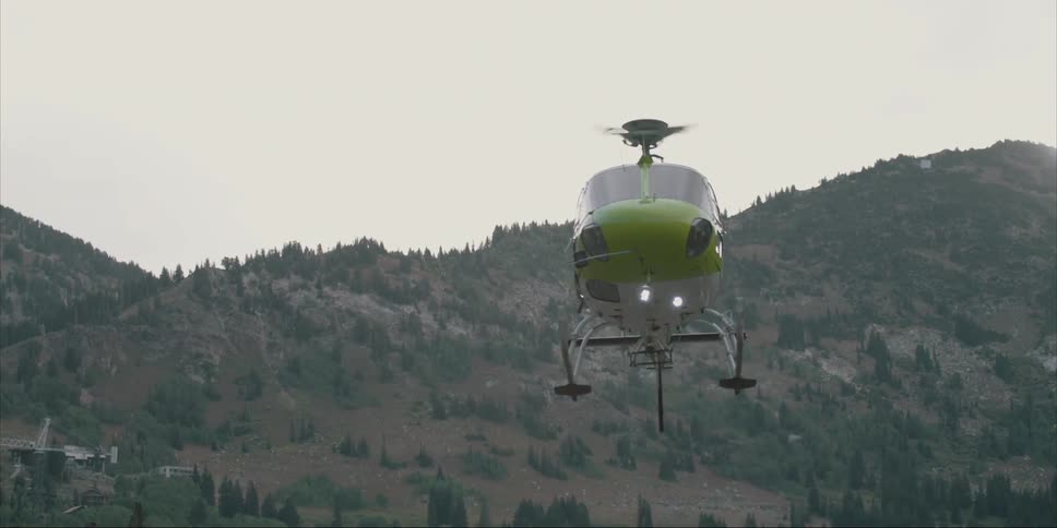 A helicopter lands in mountains