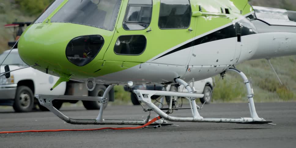 A helicopter lifts off the ground