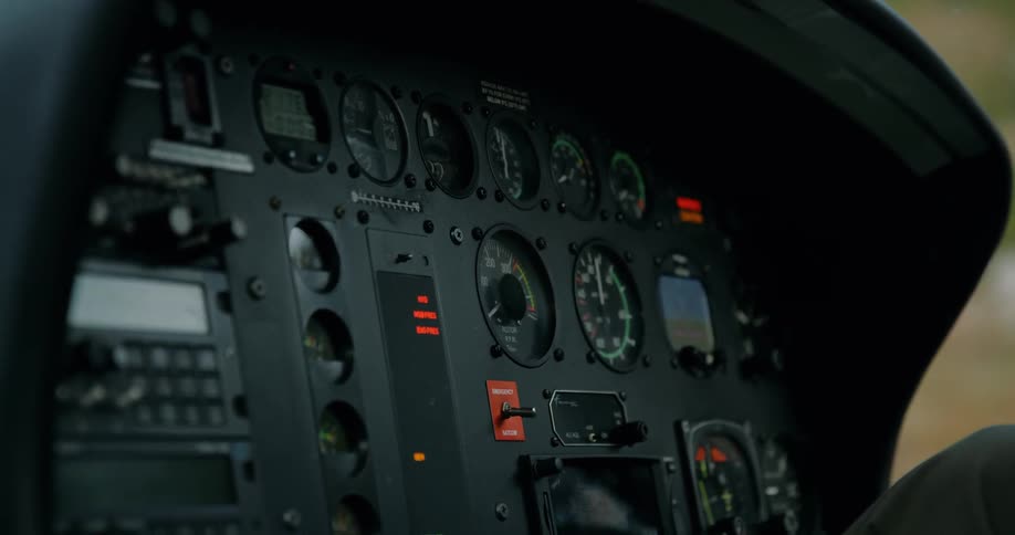 A light flashes on a helicopter dashboard
