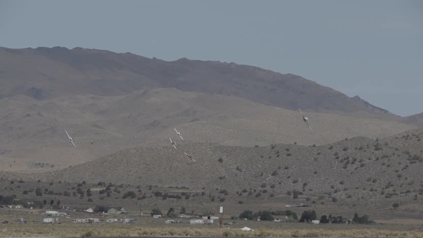 Small planes fly near a small mountain side village