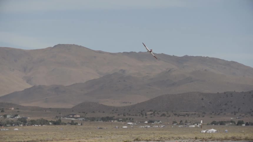 Plane flying away from a mountain range