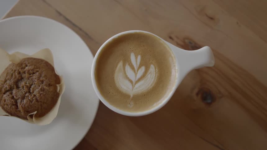 A cup of coffee and a muffin