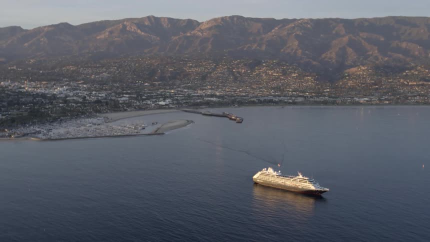A cruise ship approaching shore on a sunny day