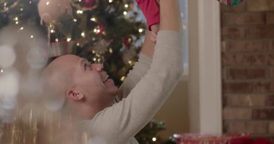 A young girl jumps into the arms of her father