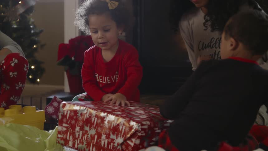 A family are opening christmas presents