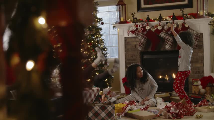 A family are playing and having fun after opening christmas presents