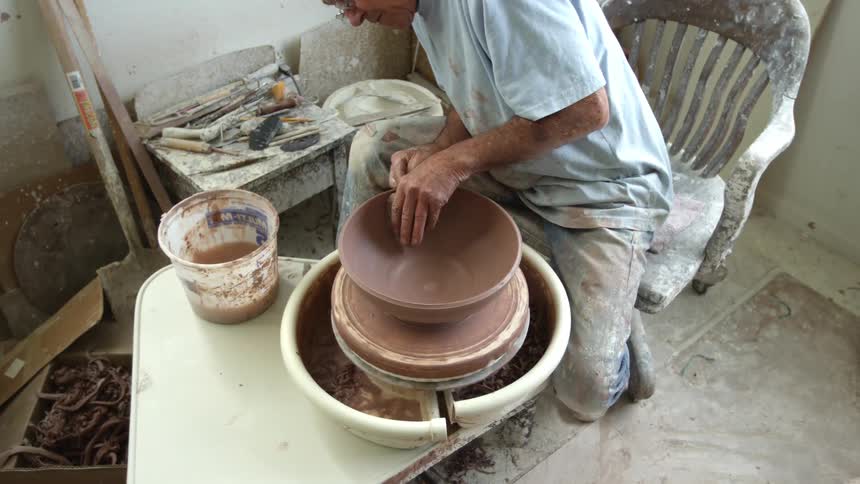Man making a bowl with clay