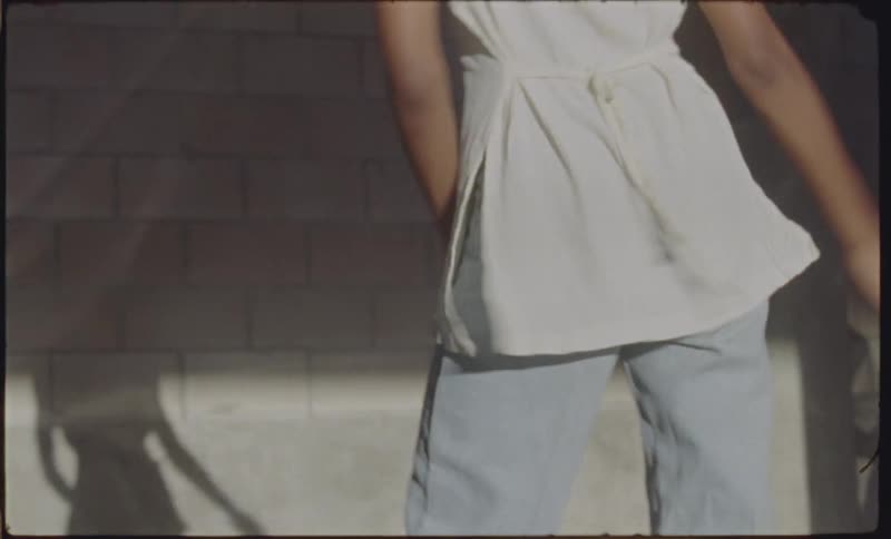 A woman dances in a parking garage