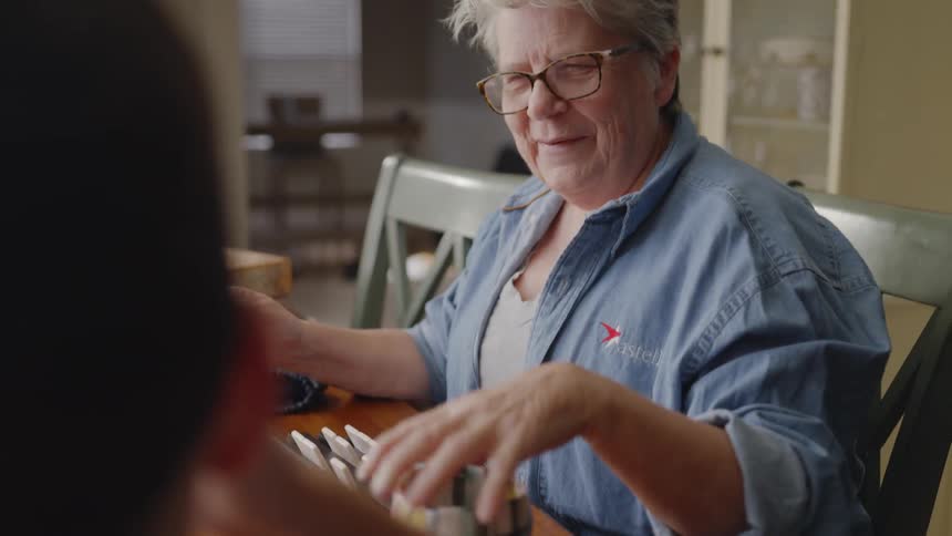 A man and woman have a conversation at a table