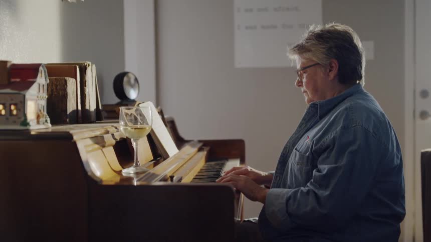 Elderly woman plays the piano