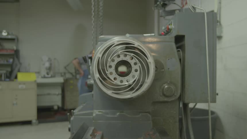 A piece of machinery runs in a factory