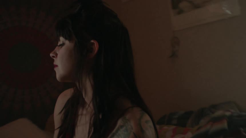 Woman falls back onto her bed