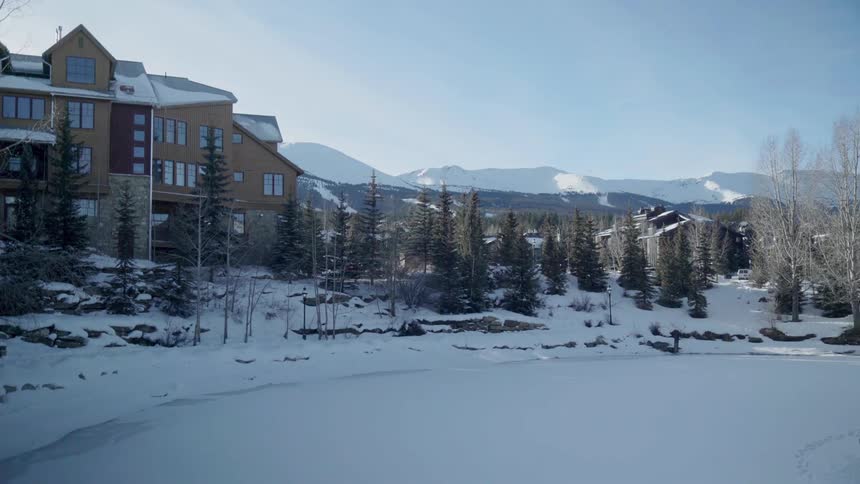 Snow covers the landscape outside of a lodge