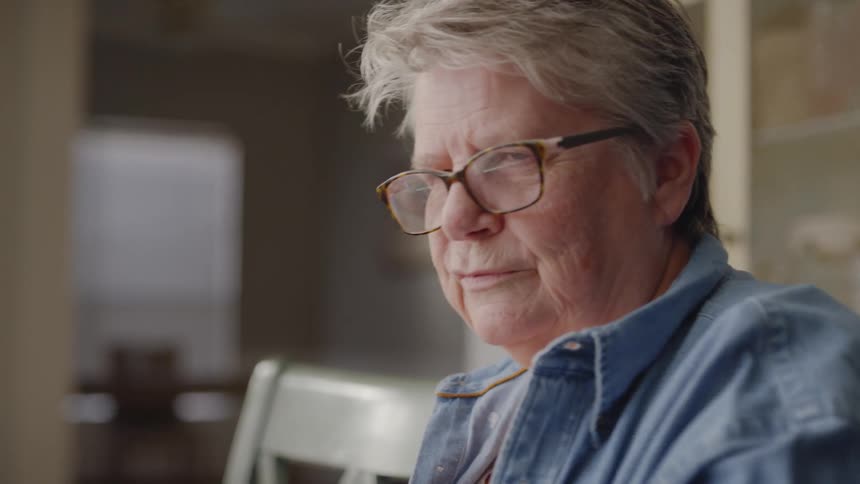 Elderly woman plays a table game with a boy