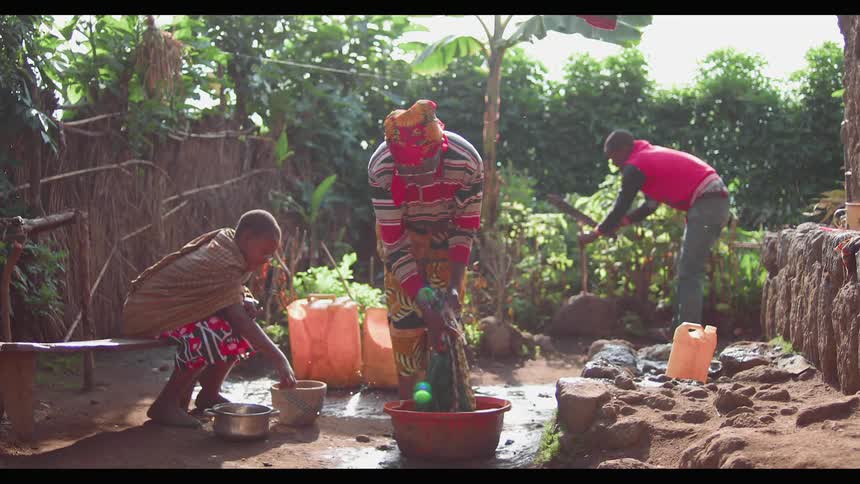 An african family are working in their garden and doing laundry during the day