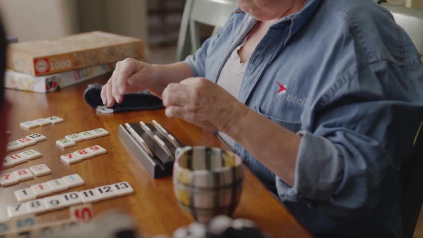 Elderly woman plays a table game with a boy