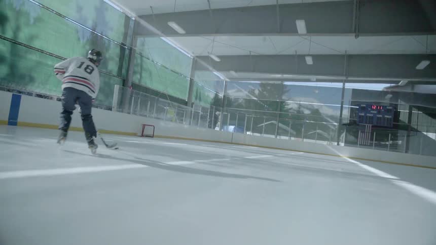 A hockey player is practicing his puck handling skills