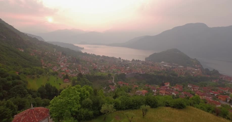 Houses in a village on a mountainside near a body of water
