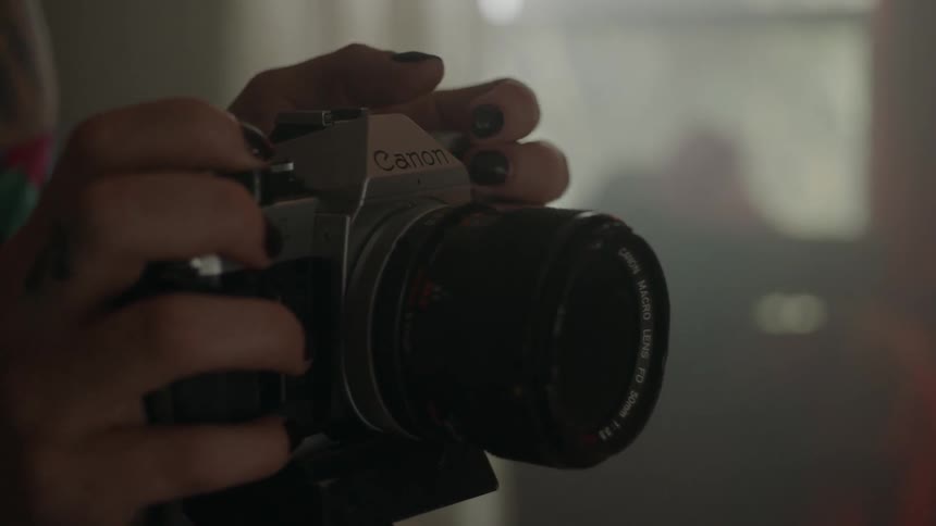 Someone is taking pictures with an old film camera
