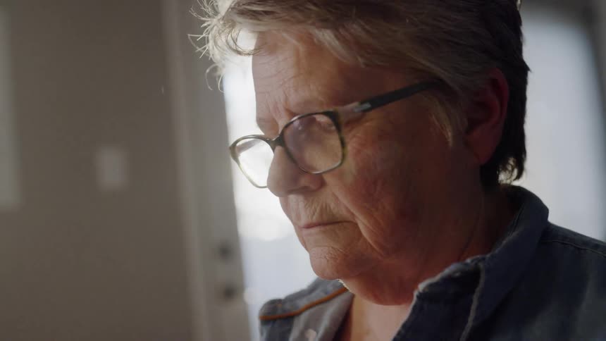 An woman sits in a sunny room