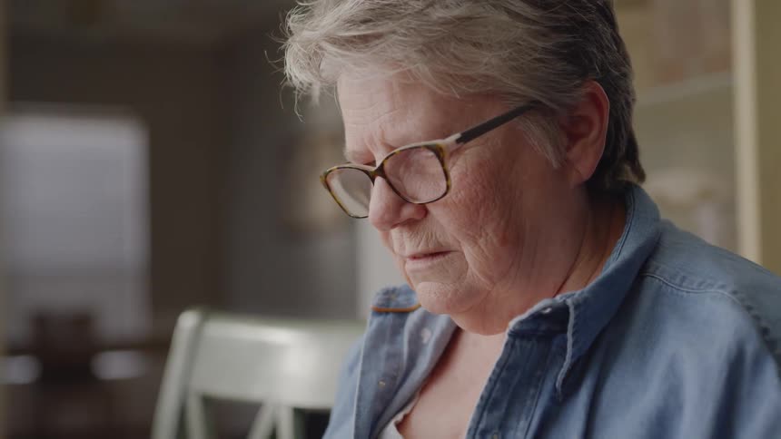 A woman is sitting at a table and talking to someone